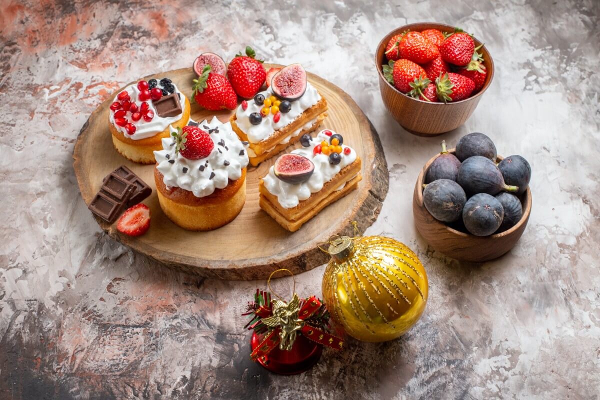 front view delicious cakes with fresh fruits light background christmas cake dessert color biscuits 1